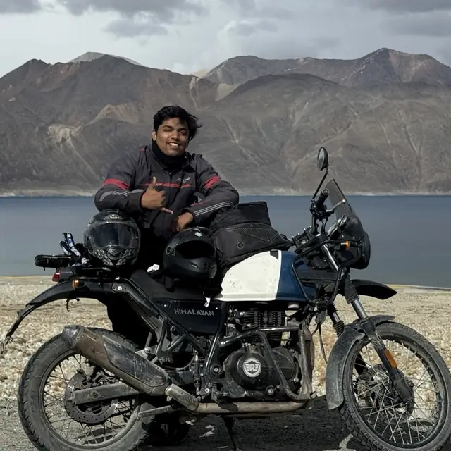 On a motorcycle ride beside a high-altitude lake in the mountains