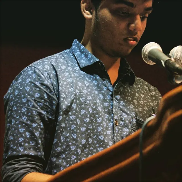 Speaking at a podium with a microphone